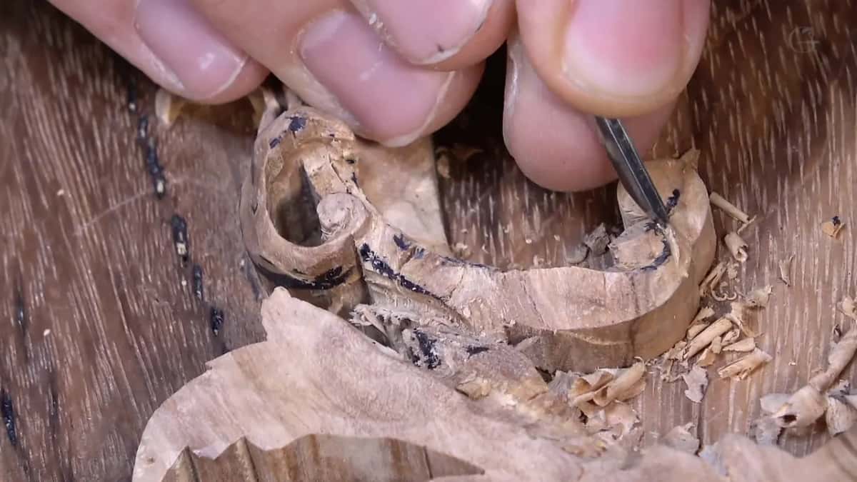 Narrow tool working the small right-hand tip of the scroll
