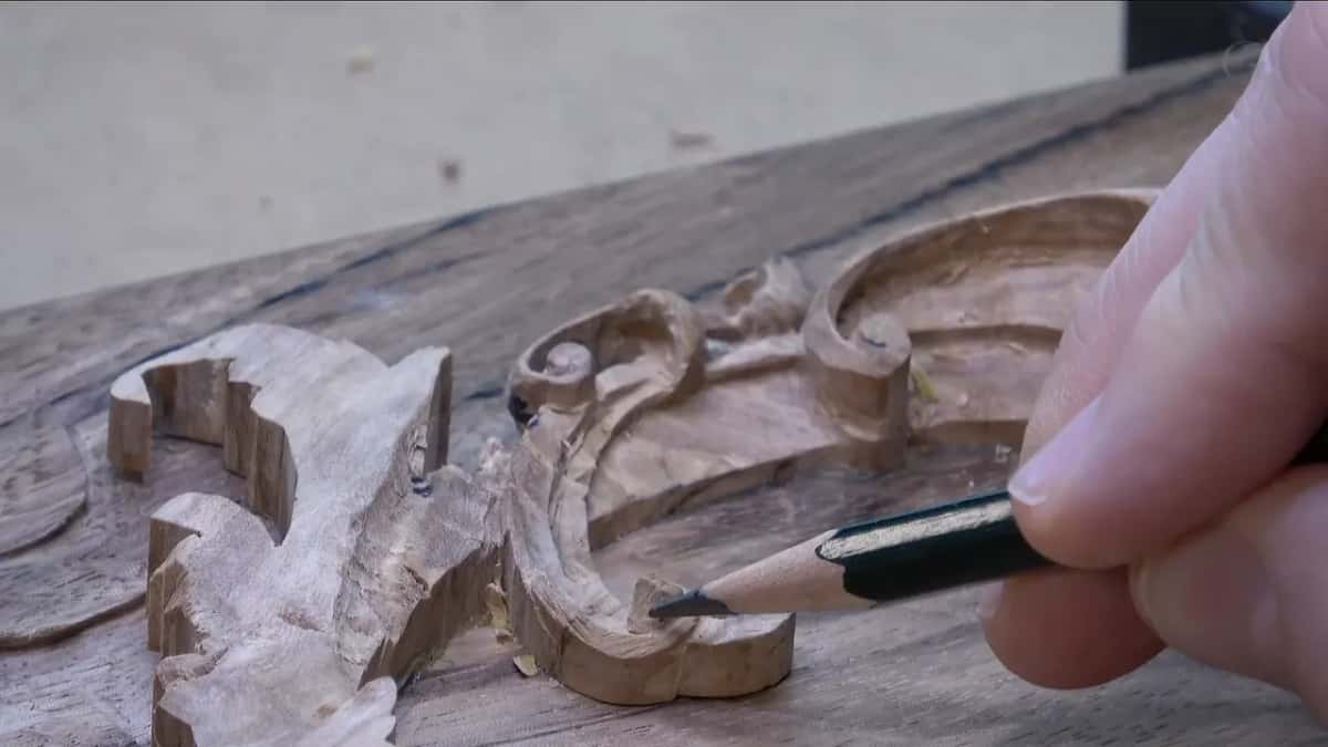 Pencil tip on the scroll's exposed side