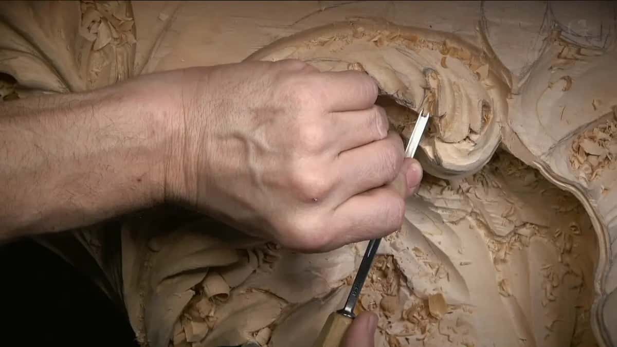 A small veiner with a wood handle works beside a curled lobe