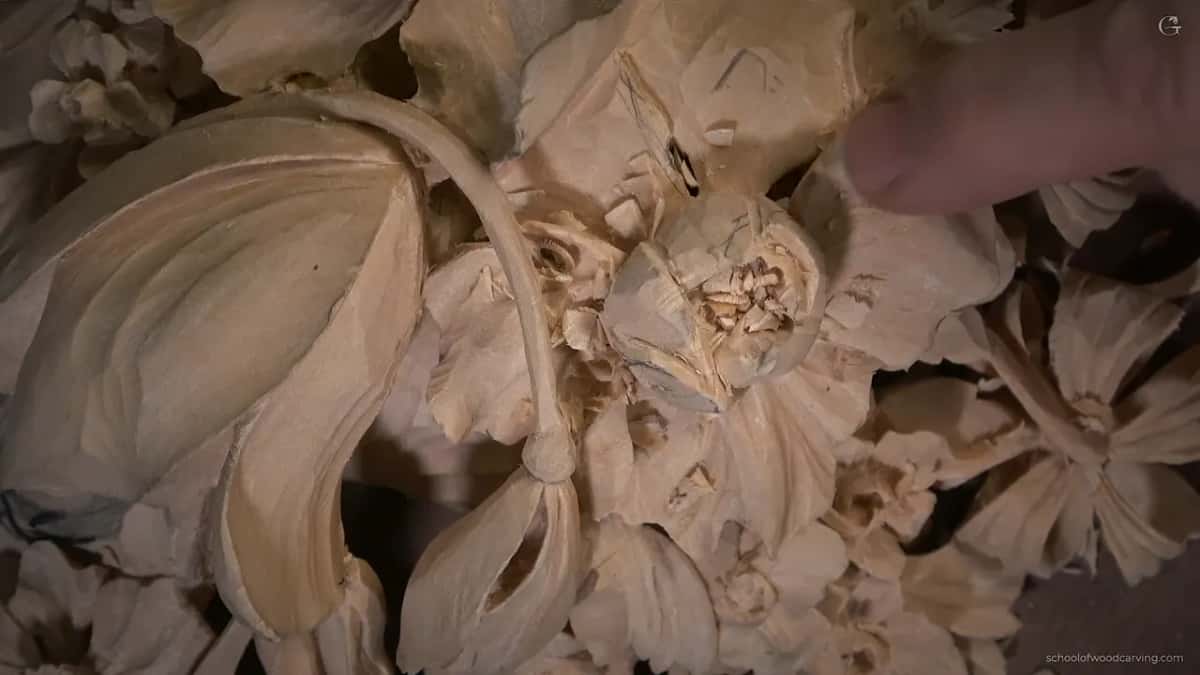 Swirl half done, chips still packed between the petals, a thumb resting above