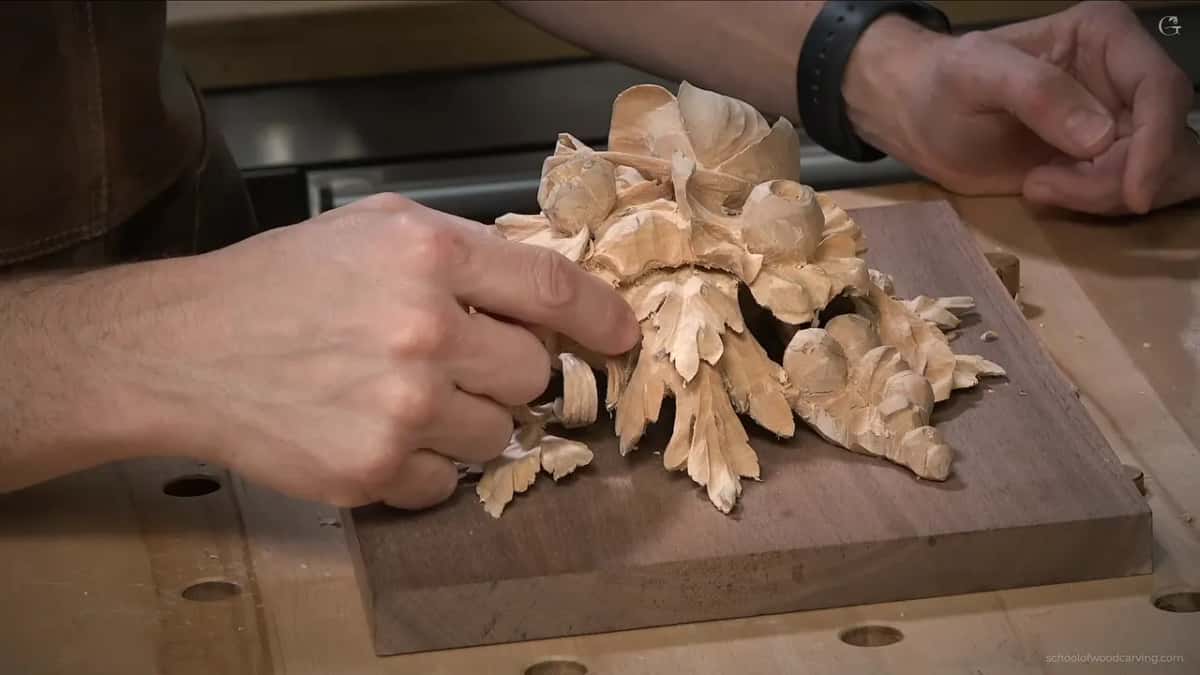 Panel lying flat, seen low from its edge, two hands near the layers