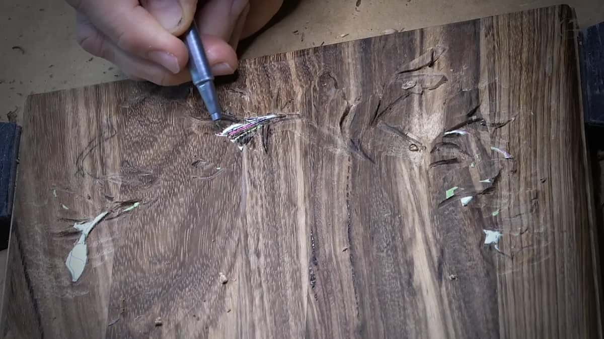 Pink and black lines on a leftover strip of pattern paper keep three crossing stems apart.