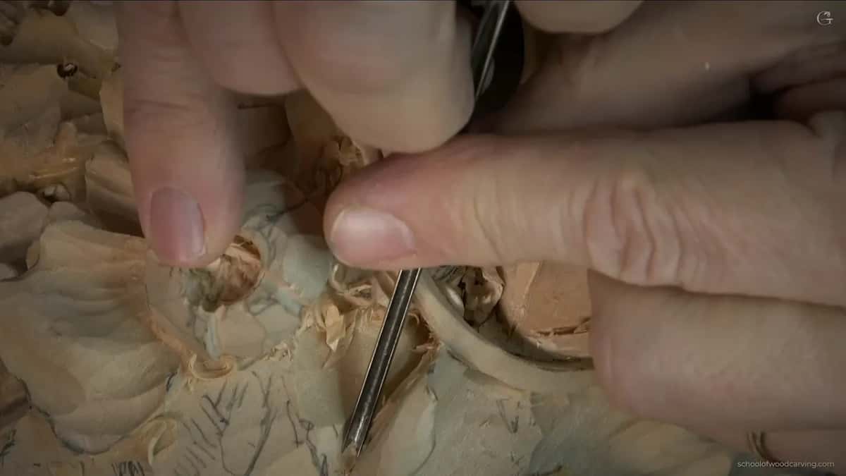 Fingers pinching a short blade