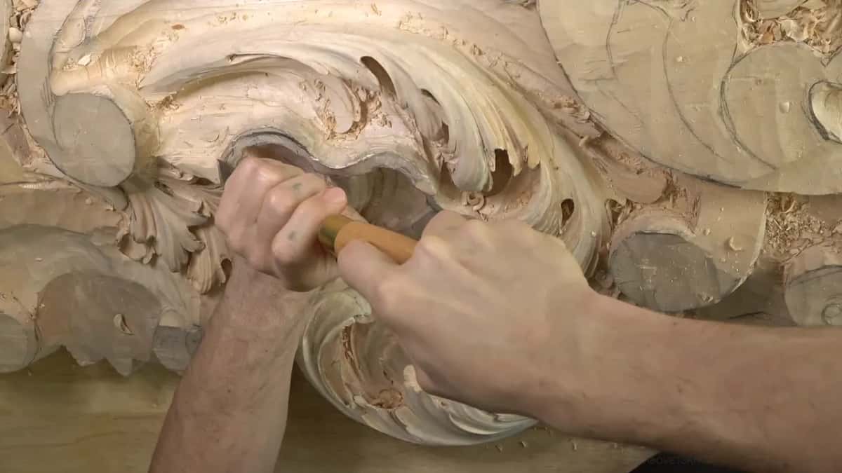 Both hands on a pale handle.