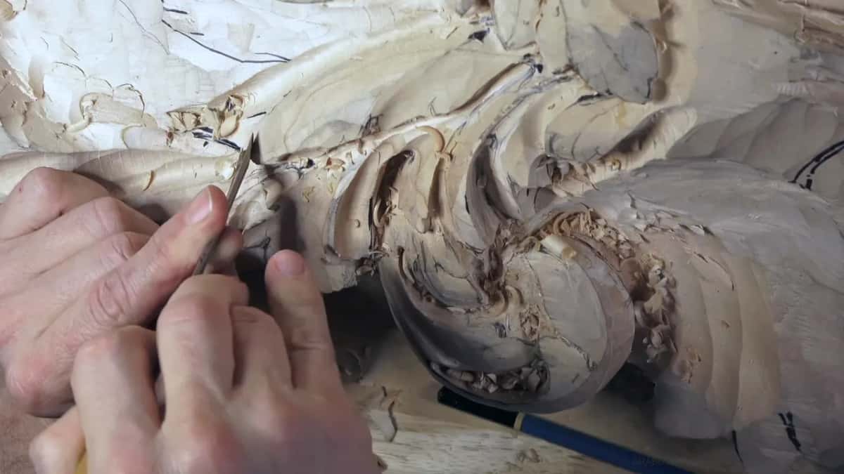 Both hands push a narrow tool into a hollow.