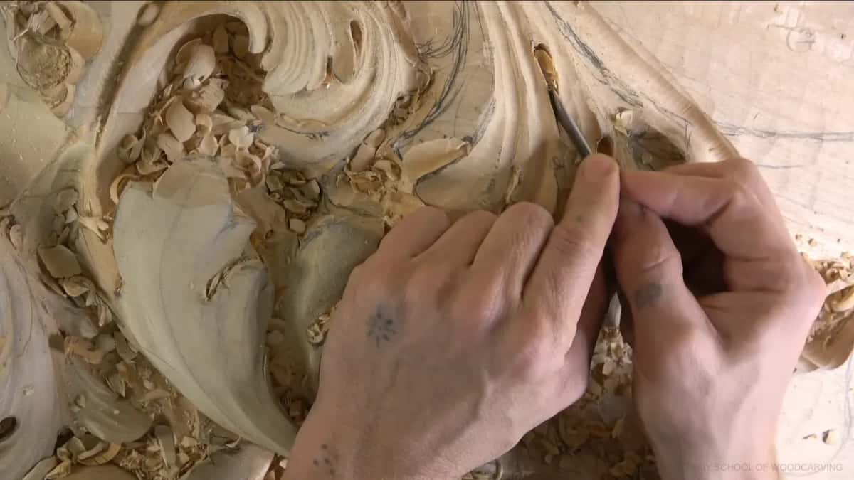 Two hands close around a small tool at a top lobe.