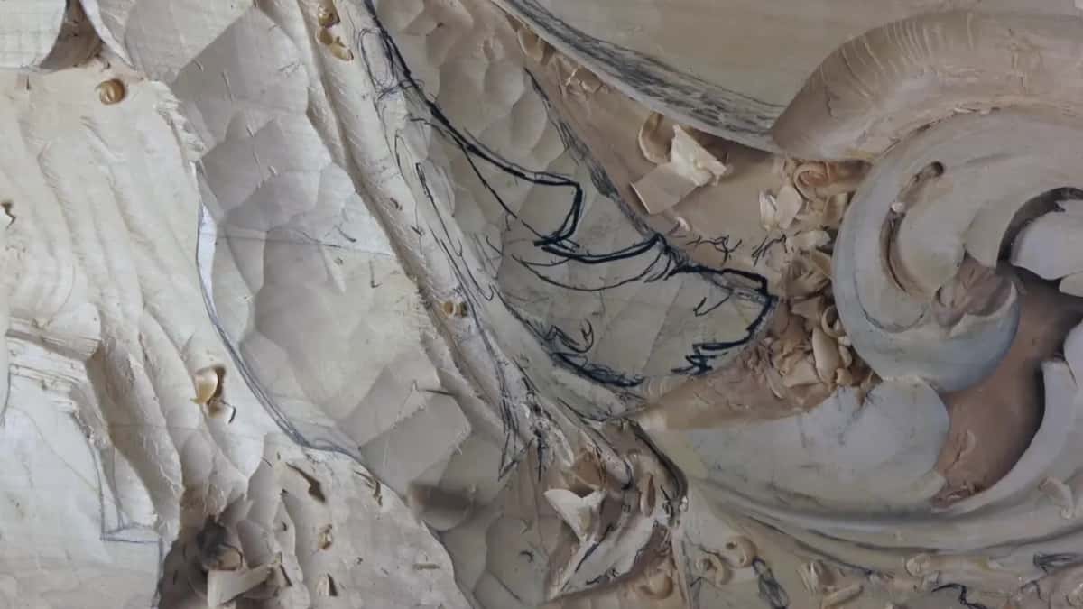 Three stages at once Coarse gouge facets to the left, marker drawing across the middle, and a finished curl throwing shadow at the right