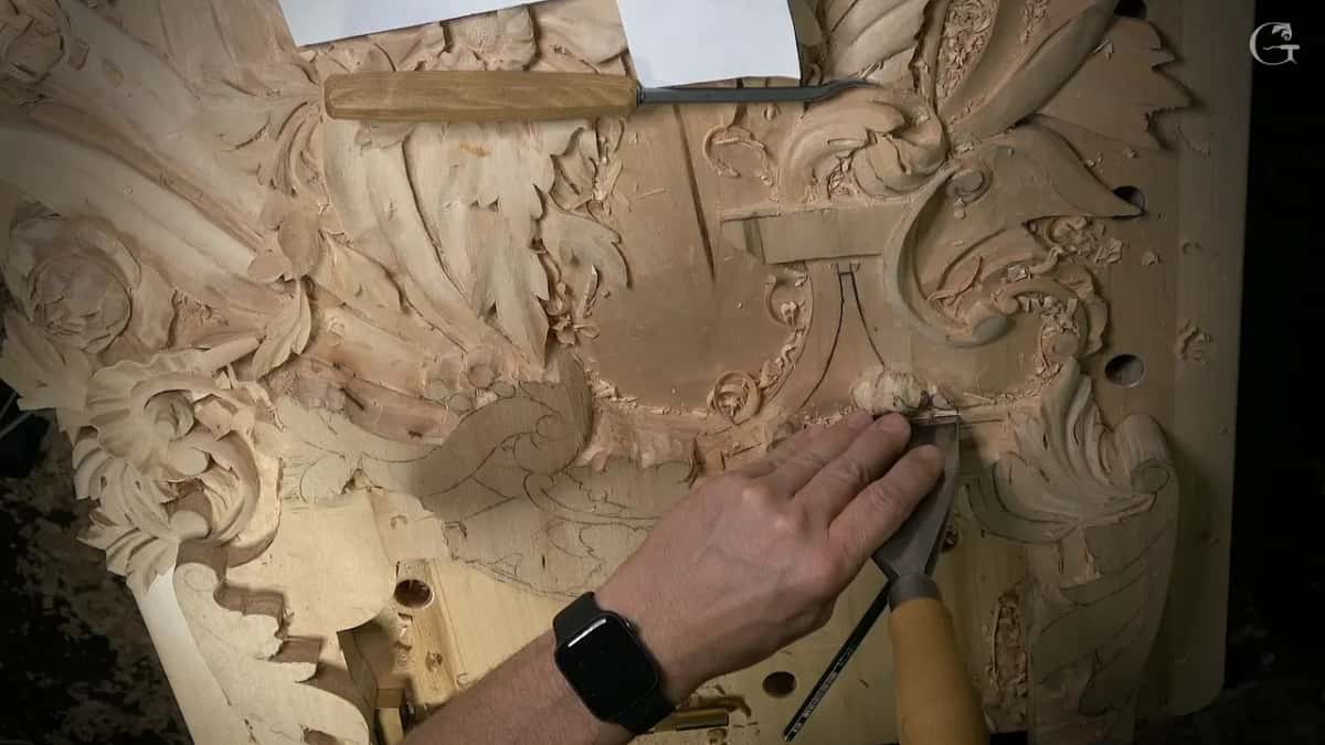 Flat palm holding the work while the other hand drives a chisel