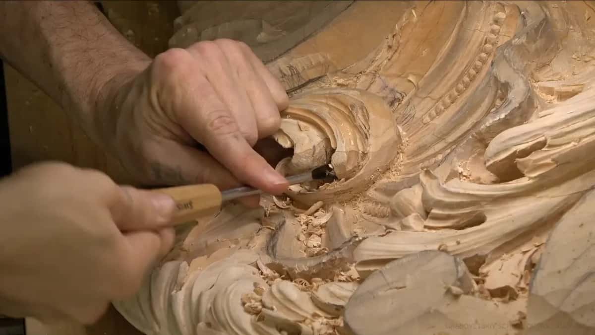 Carving by ear His forearm across the work and the gouge pushed into a dark undercut the camera cannot follow