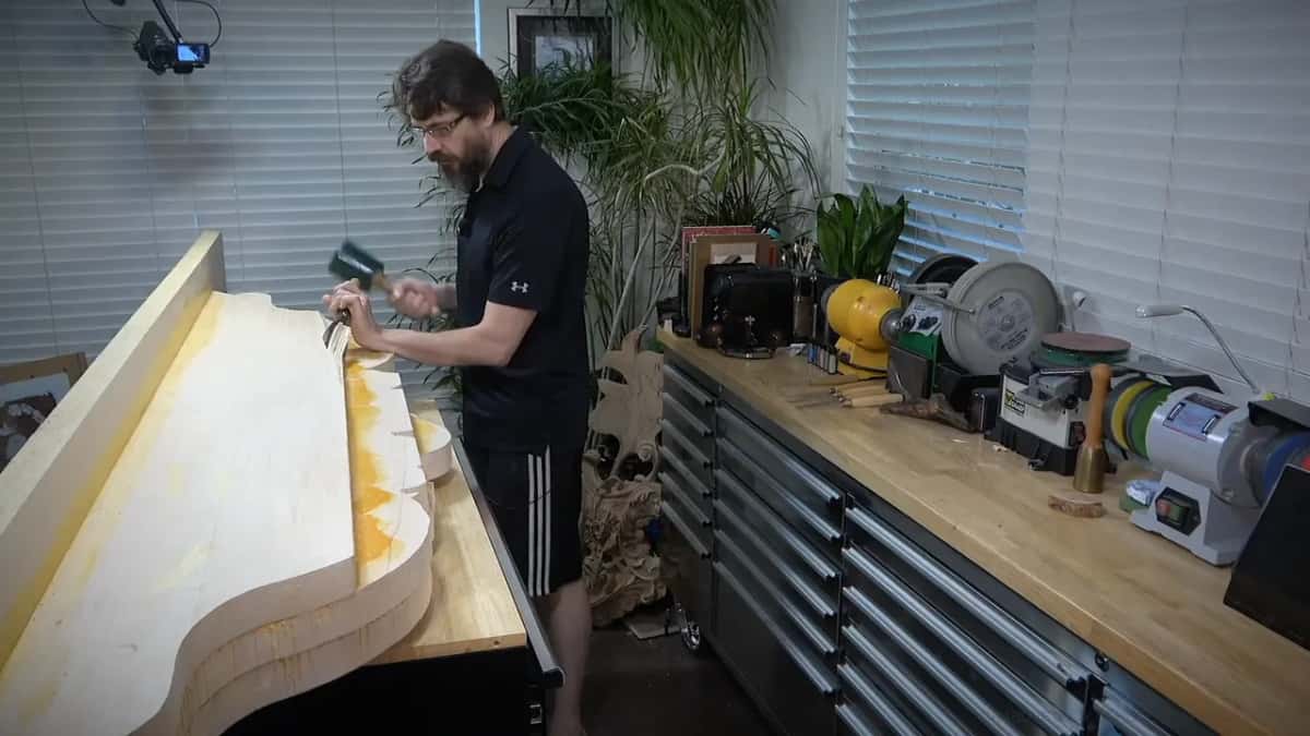 Mallet and gouge A mallet in one hand and a gouge in the other