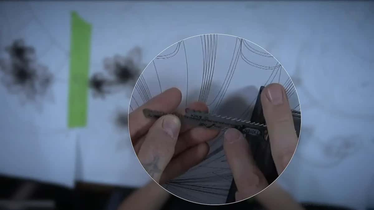 Reading the teeth Magnified inset of the saw teeth held between his own finger and thumb