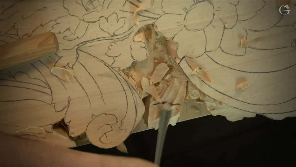 Chips pile up in a lowered hollow while a gouge works its edge.