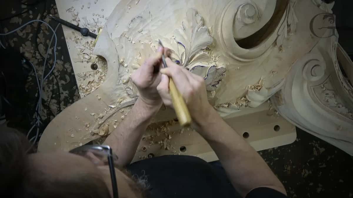 Seen from above, both hands on a long handle.