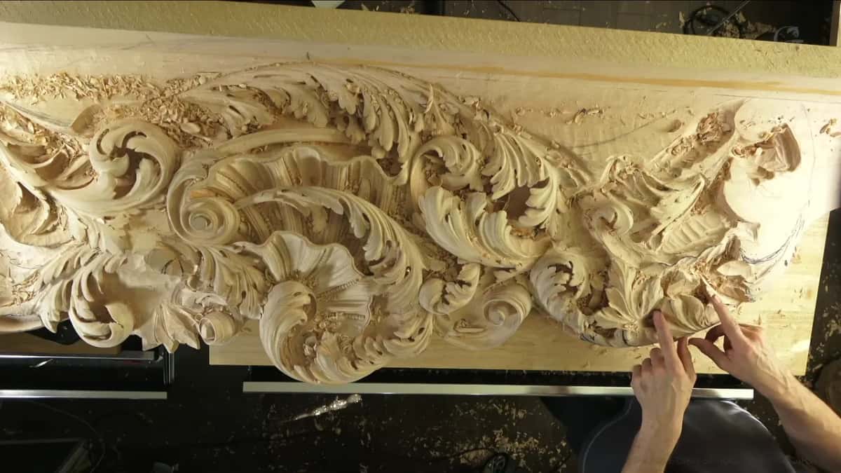 The long ceiling board seen from above, acanthus scrolls running across its whole length.
