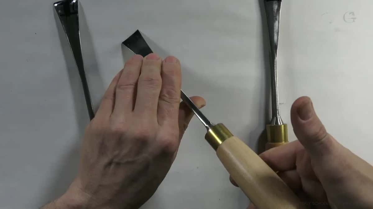 Lifted from the group, one gouge turns its bevel toward the lens while two wait behind.