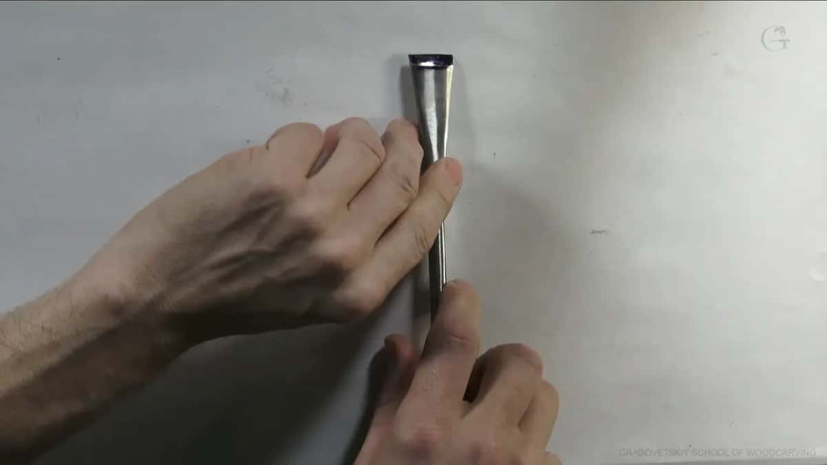 Hand closed around the handle.