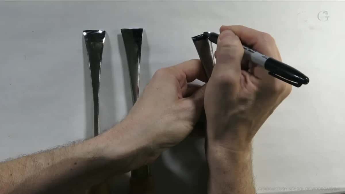 Pen in hand beside the three tools.