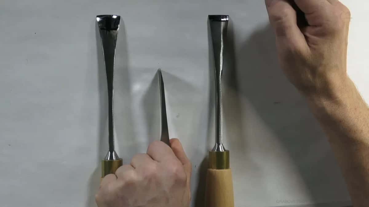 Blade close, the ground face catching light all the way along its length to the tip.