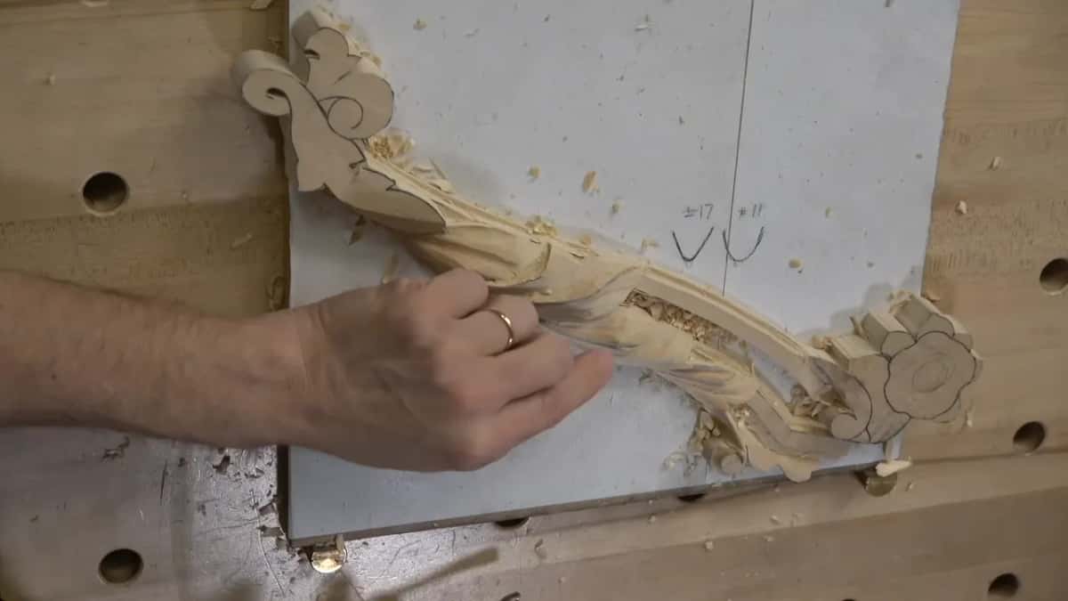 Palm flat on the carving while the far side gets the same treatment it just had.