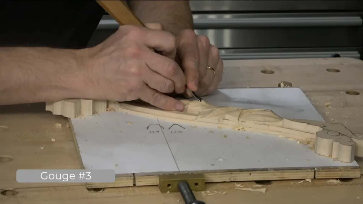 Backbent again, with a pencil still in the other hand.