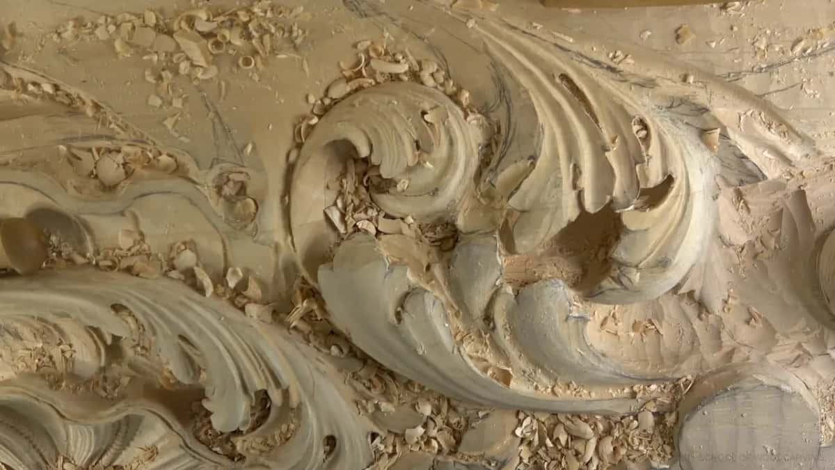 Wide view of the carved leaves and the dark pocket at their center.