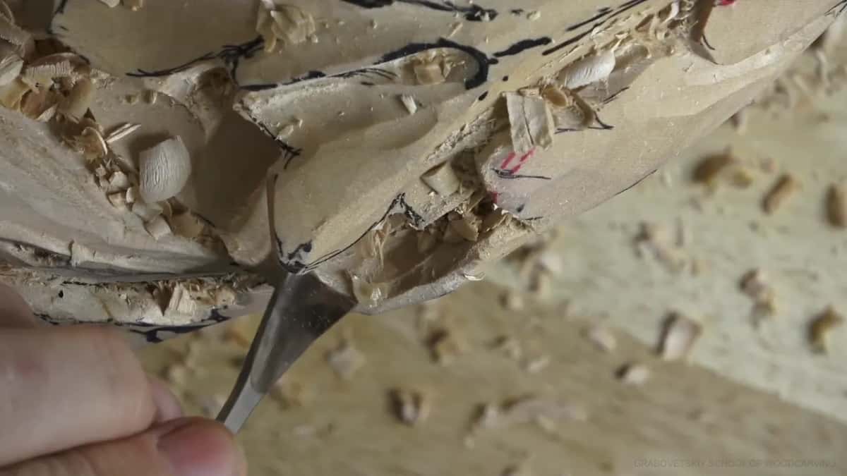 Wider blade in the slot, a loose chip beside it.
