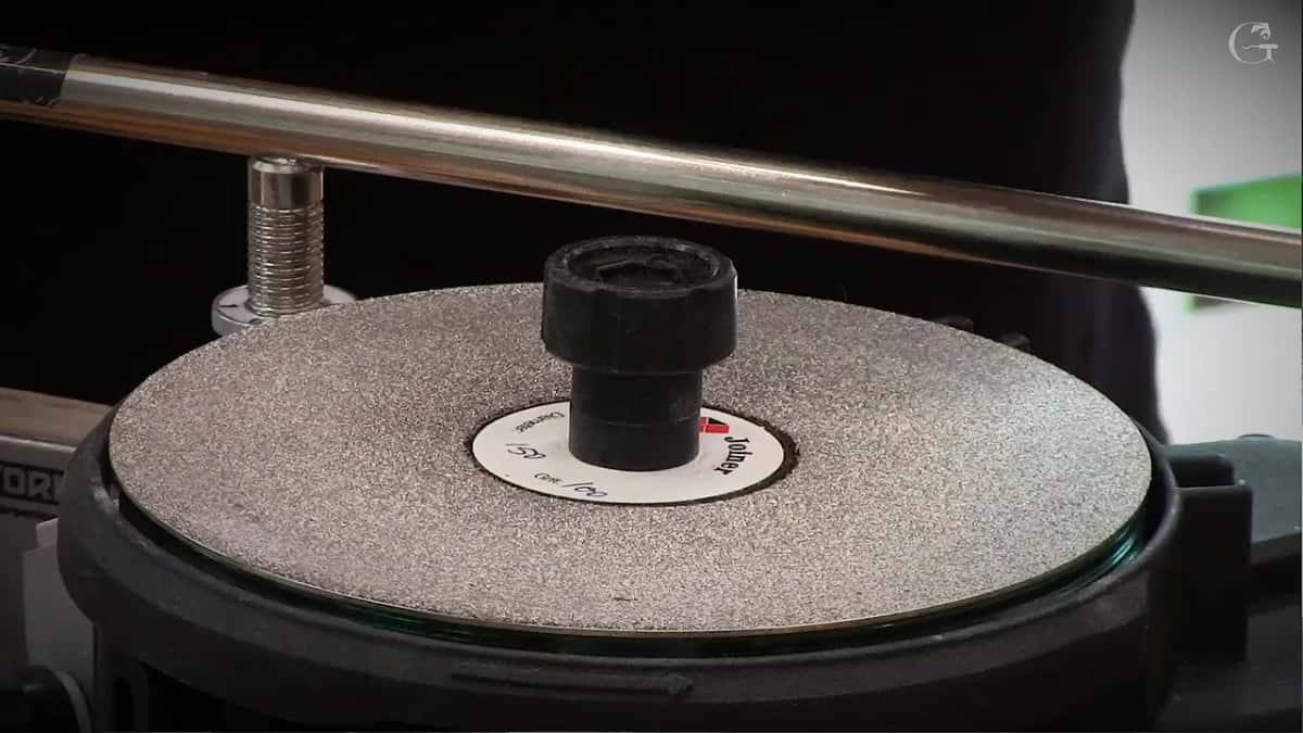Bare abrasive disc with the guide bar above it, still nothing clamped in yet