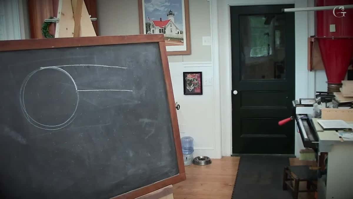 Circle of chalk standing for a grinder wheel, with straight lines run against it to show where steel gets scooped away