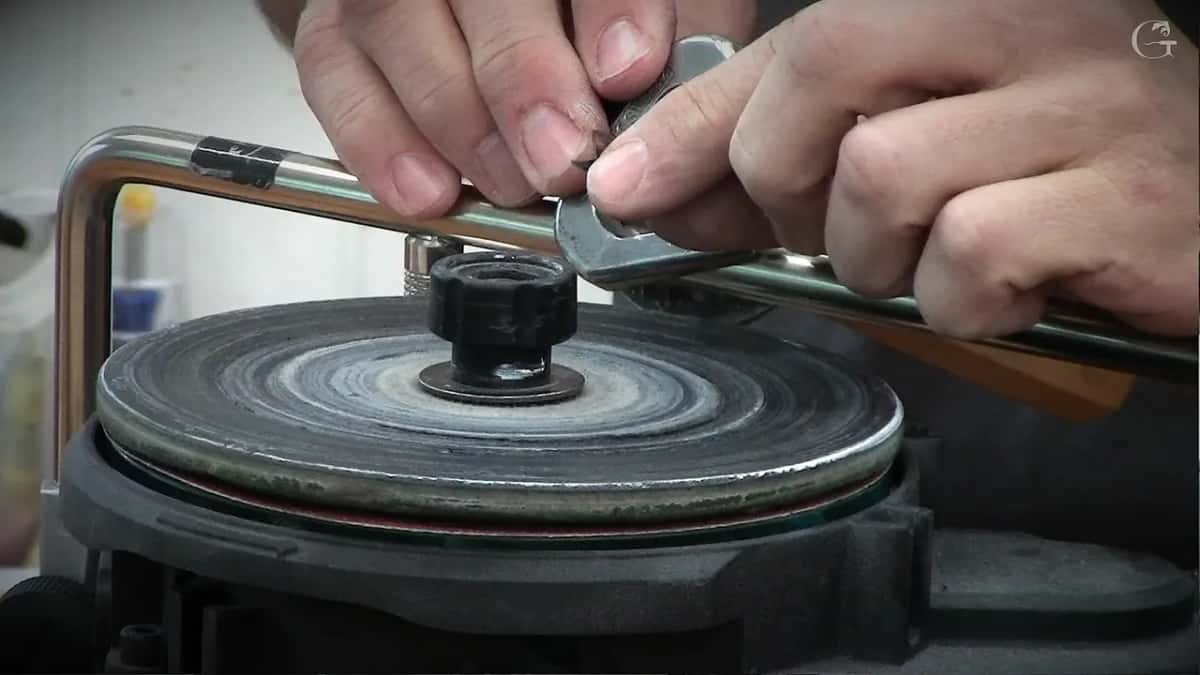 Easing the blade sideways by a hair against the wheel