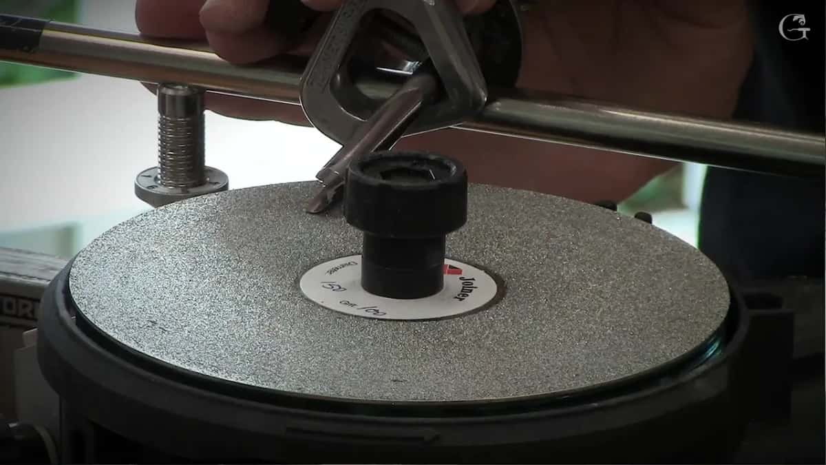 Jig rides the bar with the blade down on the abrasive