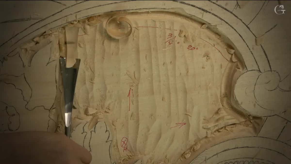 Gouge laid in the hollow, a curl beside it.