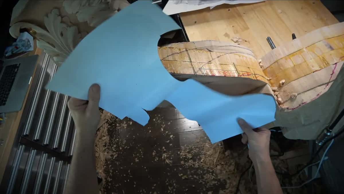 Blue paper Two big blue paper templates held up in both hands above the taped blank