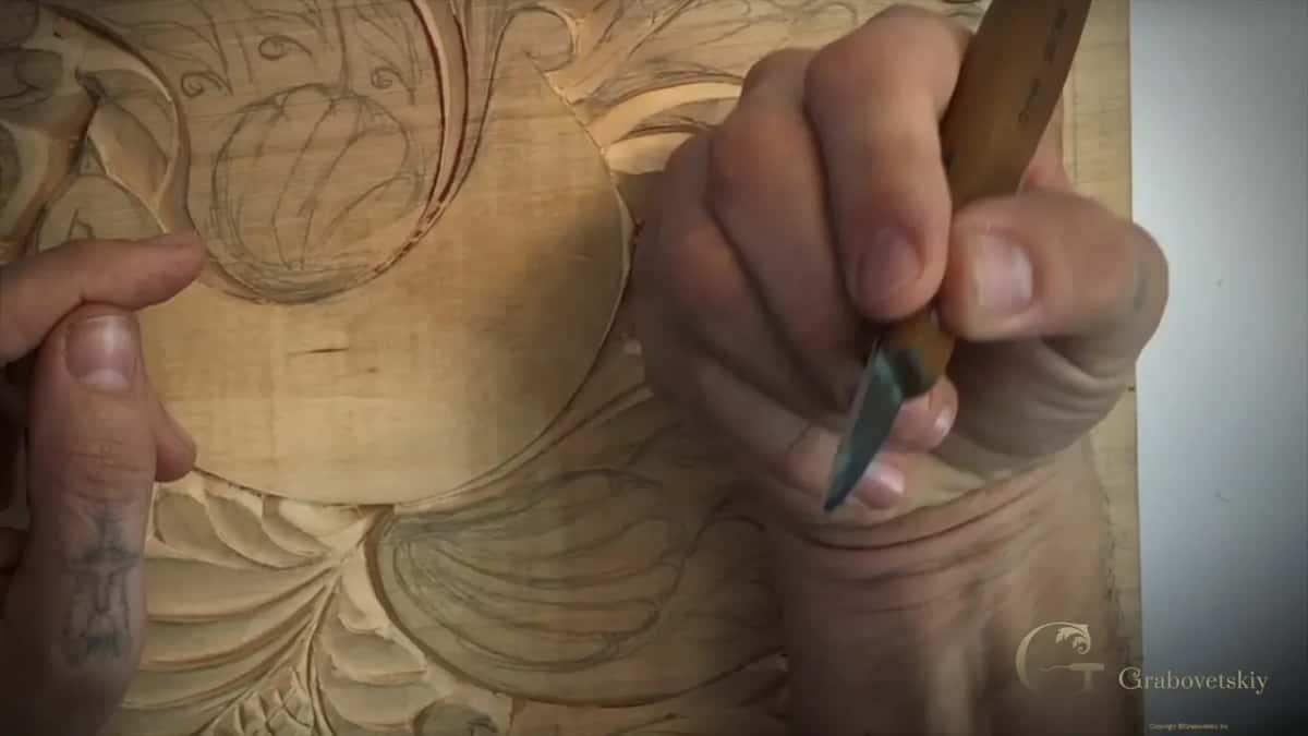 Three fingers and a thumb, the same hold you would use for writing a letter.