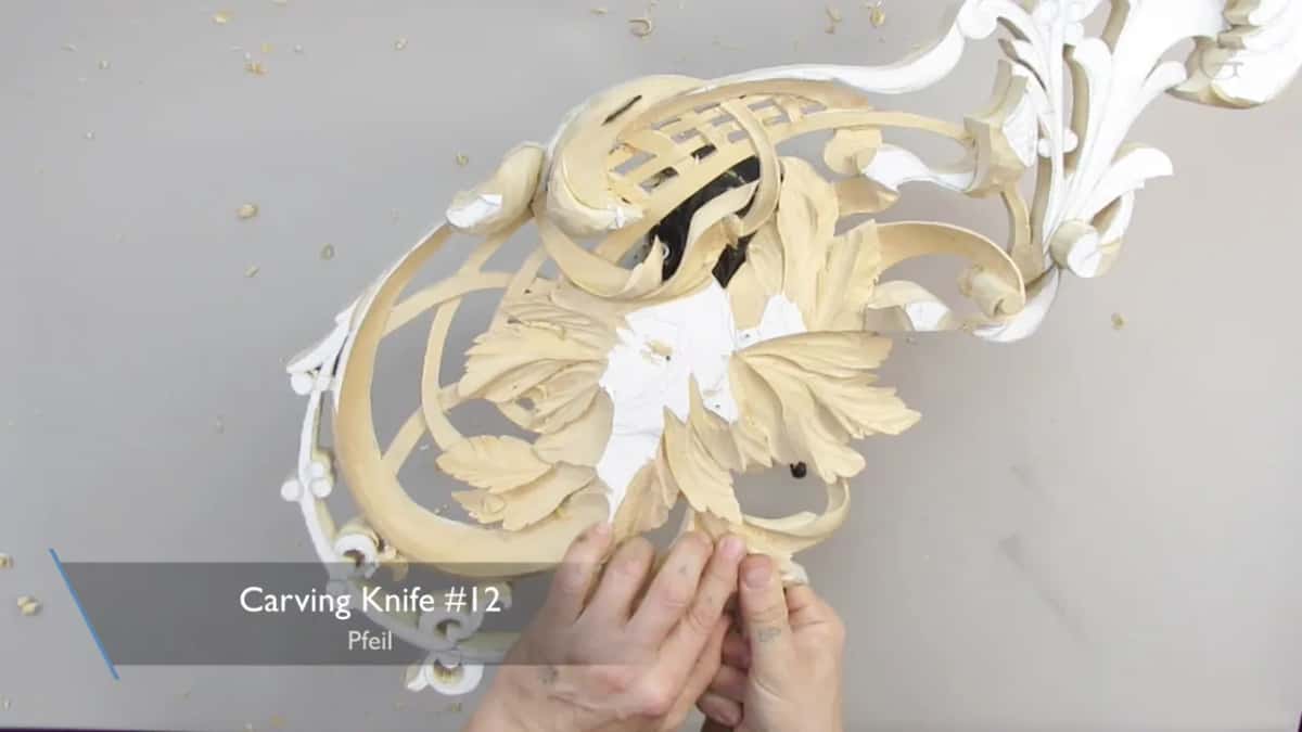 Both hands down at the lower edge, a carving knife card on the screen