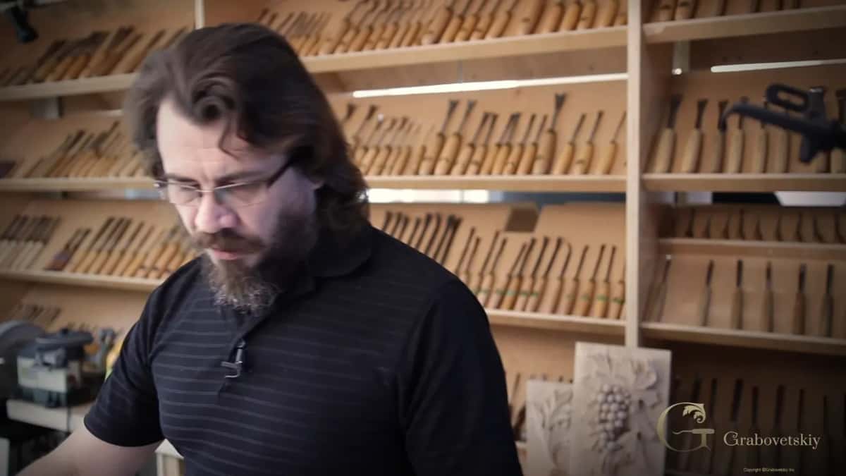 Hundreds of gouges on the wall behind him.