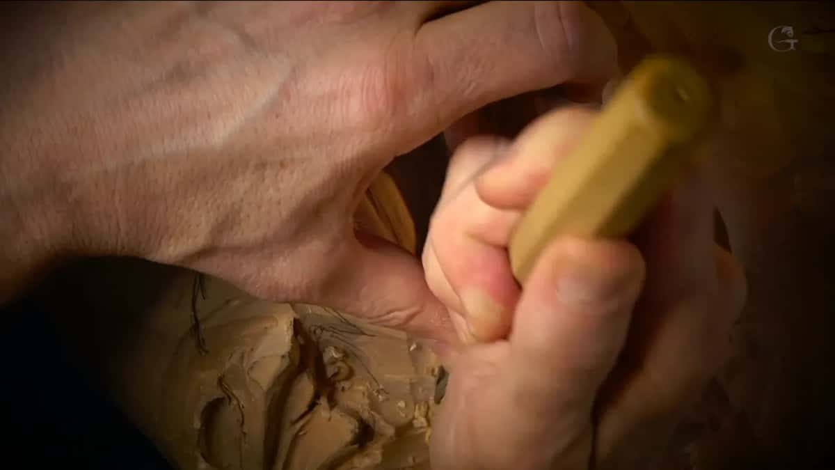 Both hands around an octagonal handle.