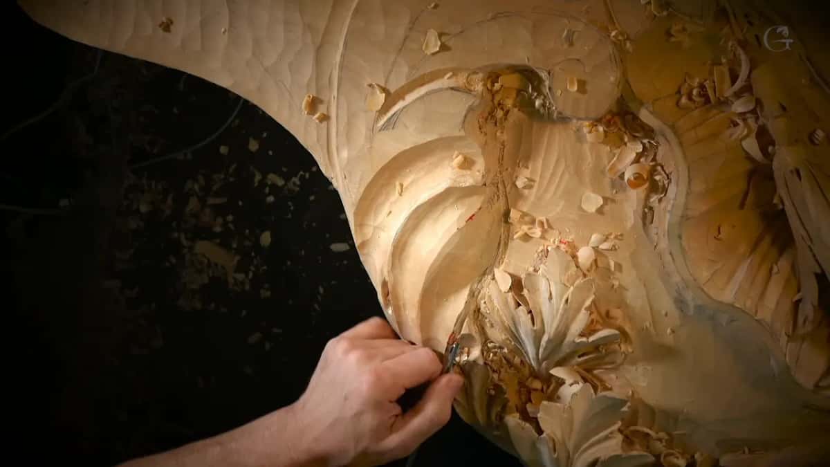 From above, a small tool works a leaf.