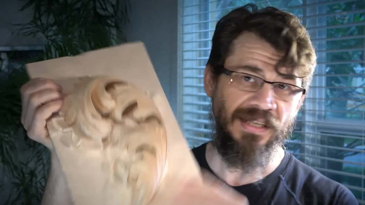 Part carved Byzantine acanthus leaf, held up.