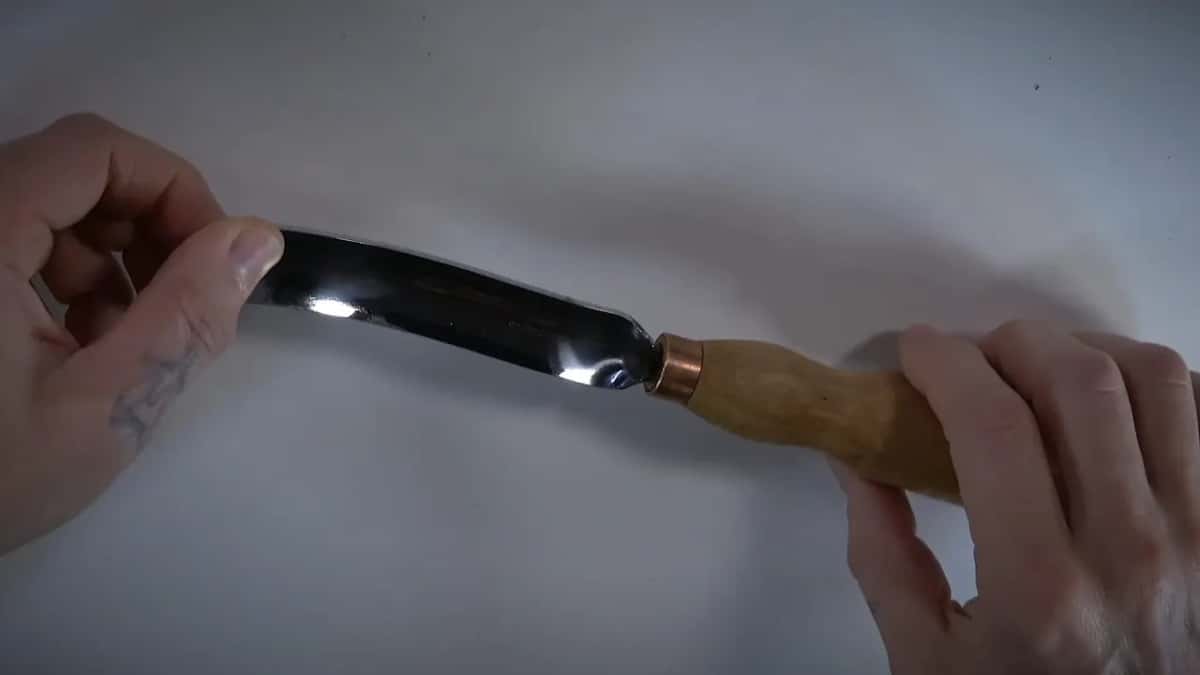 Long bent gouge, copper ferrule, both hands.