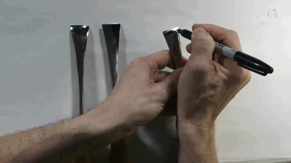 Three blades of one sweep on white, a marker pointing at the third.