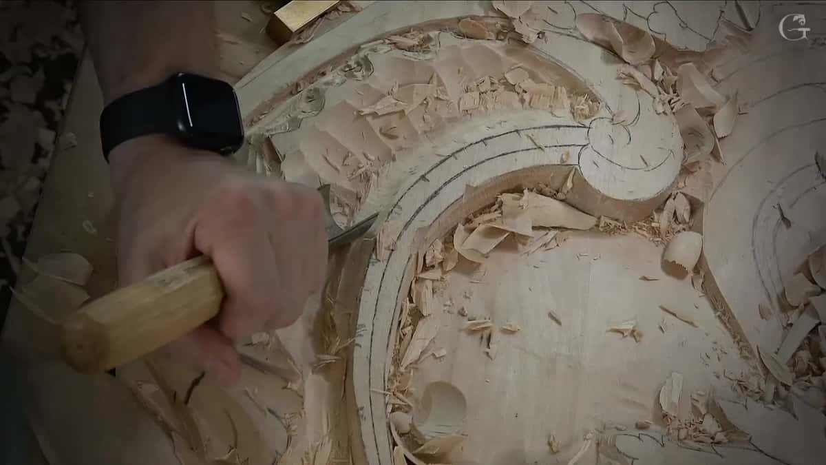 Octagonal handle in a fist, its blade low in the curved band with chips all around