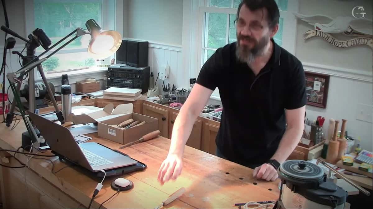 Both hands apart on the bench, marking out the space a tool wants either side of it.