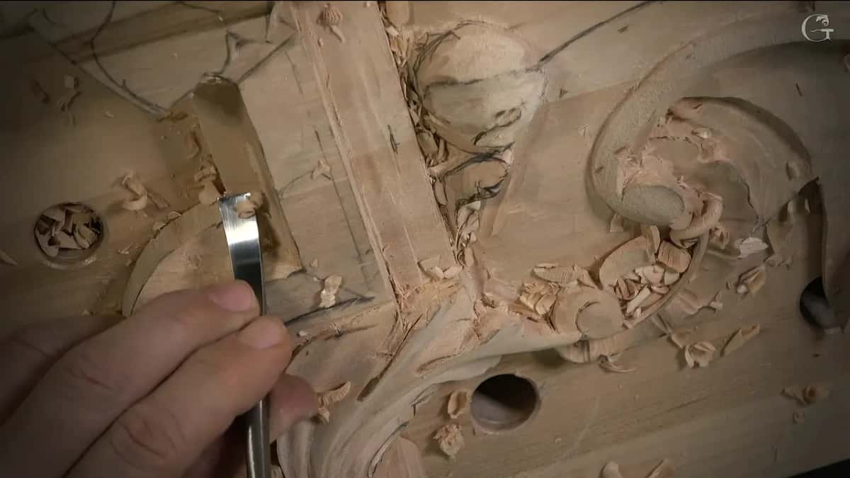 Narrow blade upright beside a bench hole full of chips
