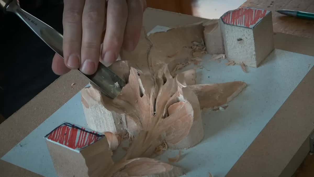 Gouge deep in a lobe, one hand pressing down on the blade
