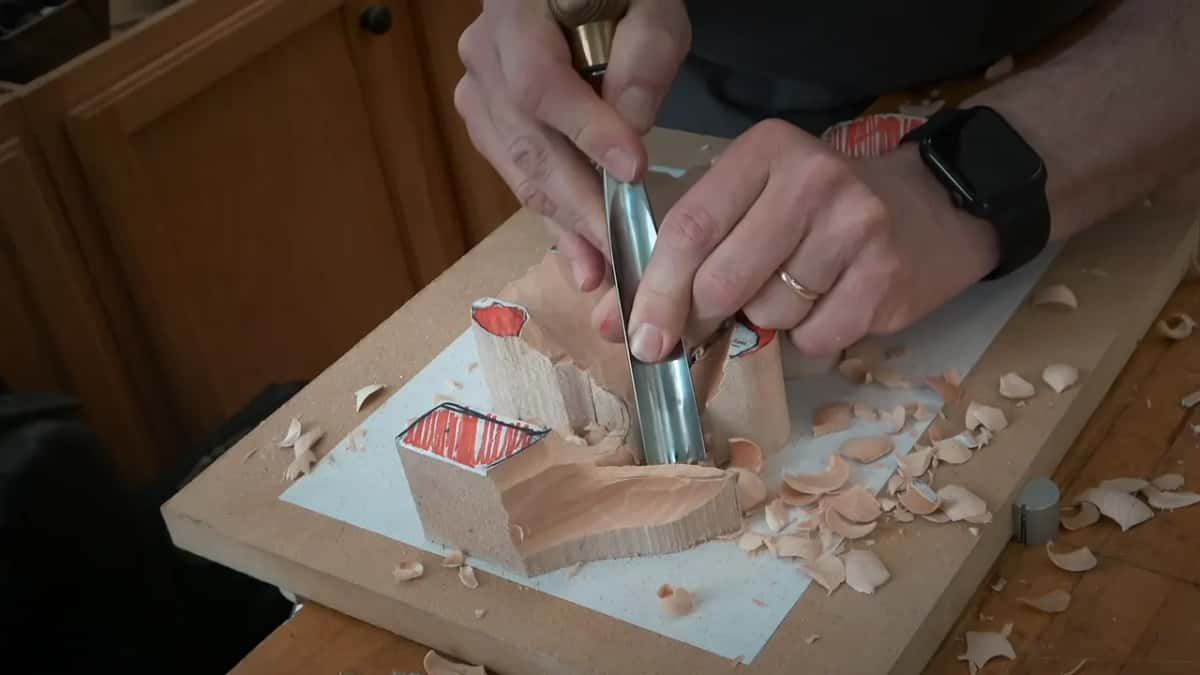 Steep angle on a gouge held in two hands against one tall side