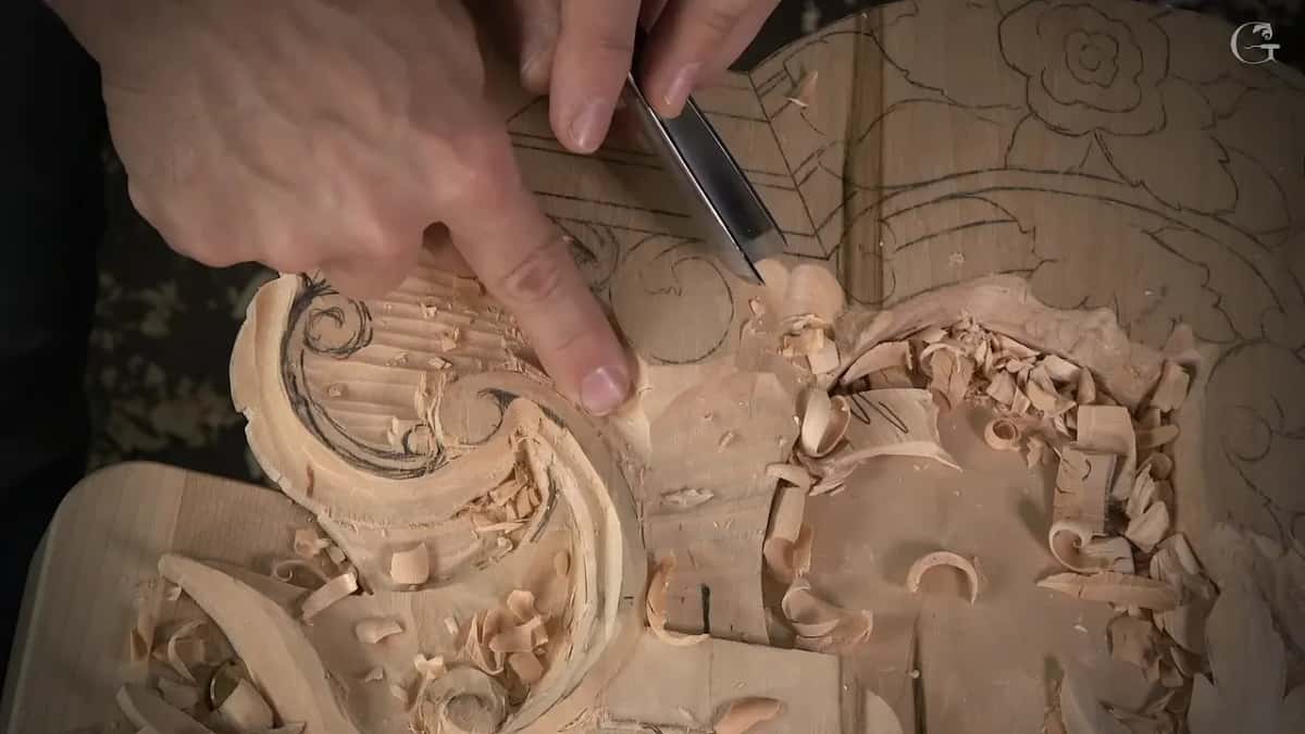 A finger points into the channel while the other hand holds the tool