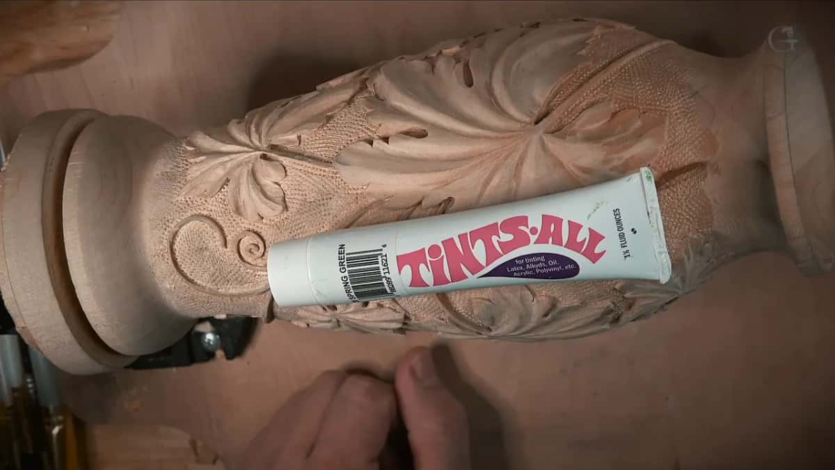 A tube of Tints-All in Spring Green lies across the punched background