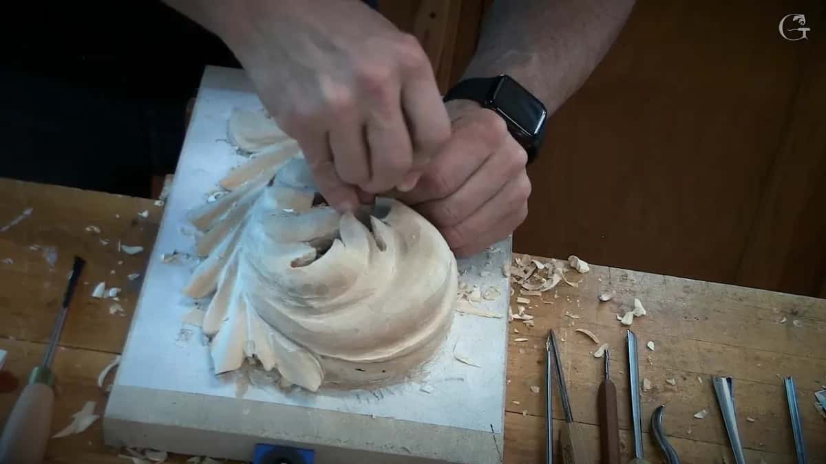 Both hands close in on the head with a small tool