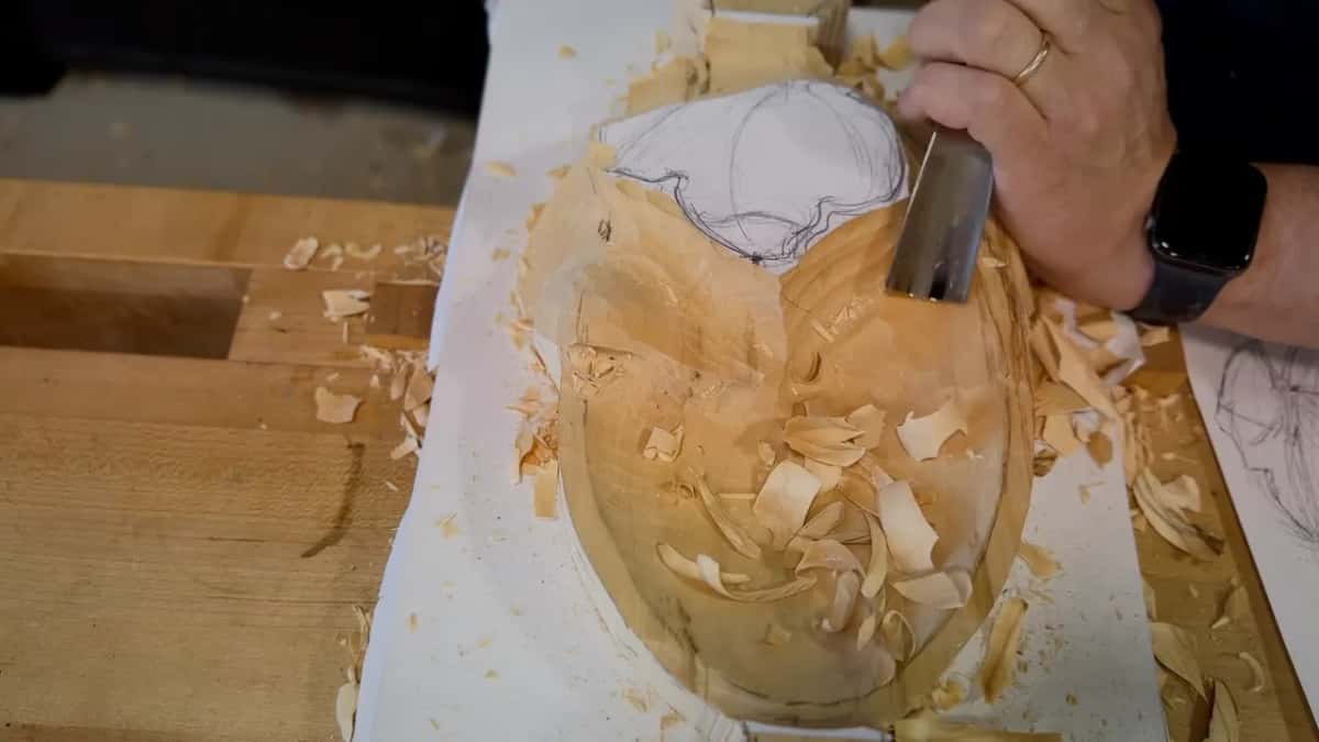 Wide gouge shaving the right side near the paper