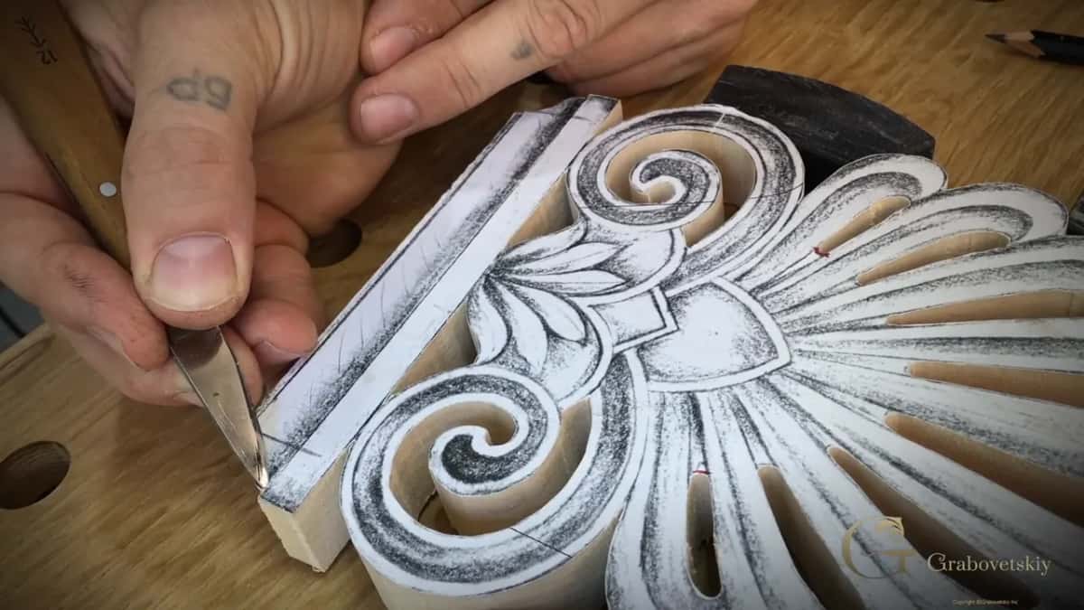 Knife tip angled into the scored line, the thumb pressing behind the blade